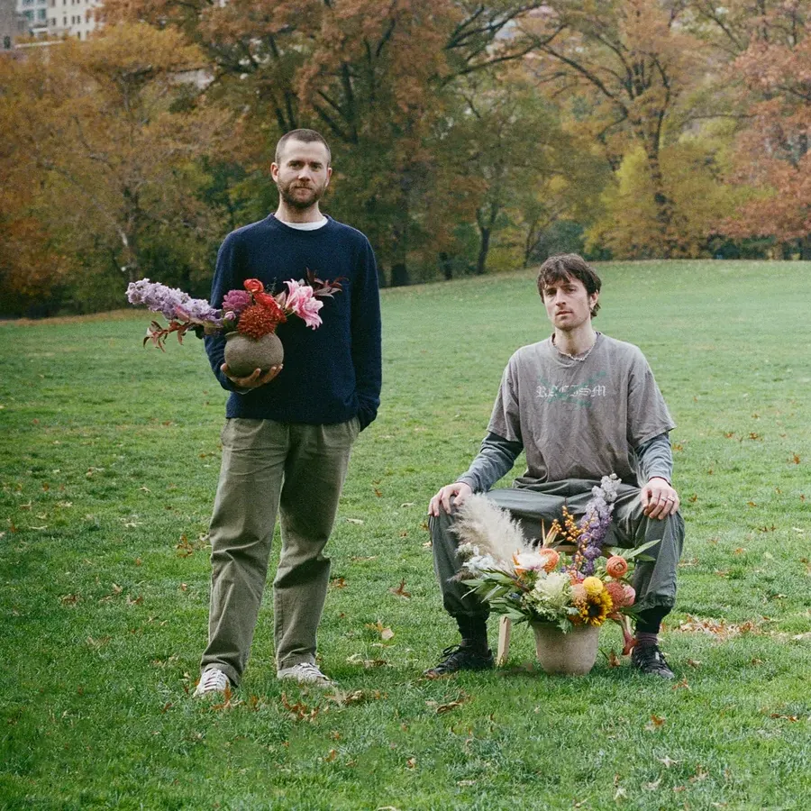 Fabian and Hugo Wood of Botanical Brothers holding flower arrangements in Central Park